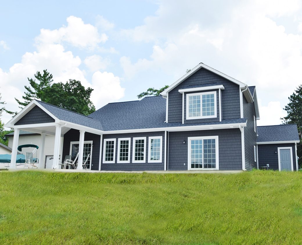 Back Exterior of a gray lake house